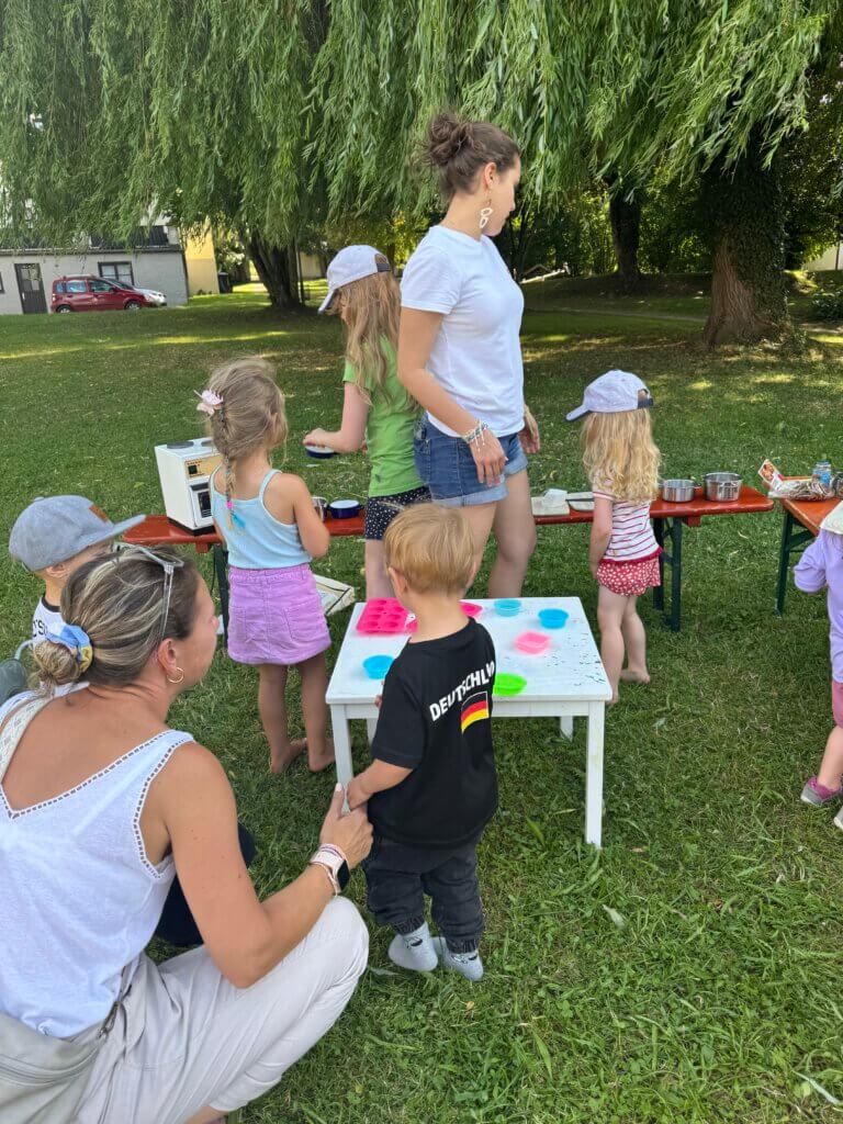 Kinder im Vorschulalter basteln ein einer Wiese.